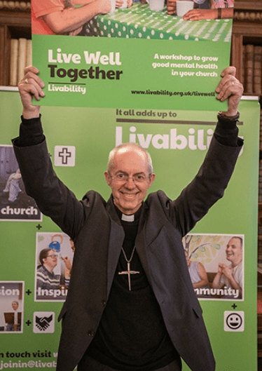 CoE Justin Welby live well together holding placard.png
